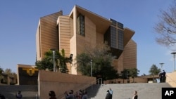 FILE - People attend a memorial service outside the Cathedral of Our Lady of Angels in Los Angeles, Jan. 19, 2021.