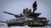 (FILE) Ukrainian soldiers practice on a tank during military training, in Ukraine, Wednesday, Dec. 6, 2023. 