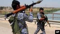 Iraqi federal policemen patrol in the town of Taji, about 20 kilometers north of Baghdad, Iraq. (File)