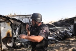 An Israeli fire and rescue personnel member works at the scene where a rocket launched from the Gaza Strip landed, causing fatalities, on a farm just over the Gaza border, in Moshav Ohad, southern Israel May 18, 2021.