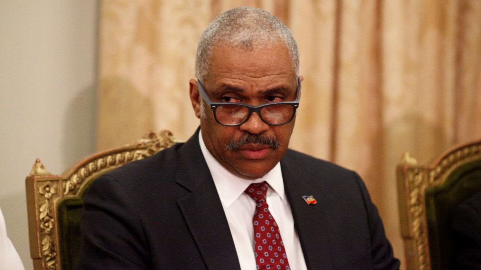 FILE - Prime Minister-designate Jack Guy Lafontant listens to a speech by President Jovenel Moise at the National Palace in Port-au-Prince, Haiti, Feb. 24, 2017.