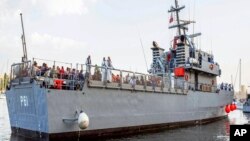 Migrants arrive on a Maltese Navy ship at the Valletta harbor, Malta, Oct. 12, 2013.