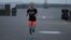 Amelia Gapin, a transgender woman from New Jersey, works out in early morning fog while preparing to run the Boston Marathon during a jog at Liberty State Park in Jersey City, New Jersey, April 18, 2017.