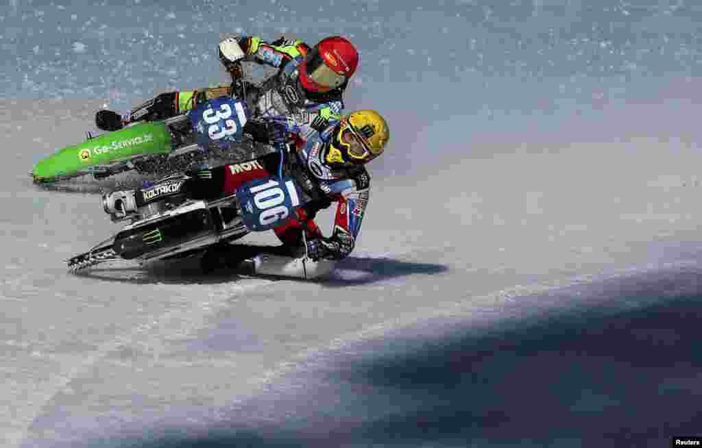 Johan Weber of Germany and Dmitry Koltakov of Russia compete during the final round of the FIM Ice Speedway Gladiators World Championship at the Medeo rink in Almaty, Kazakhstan.