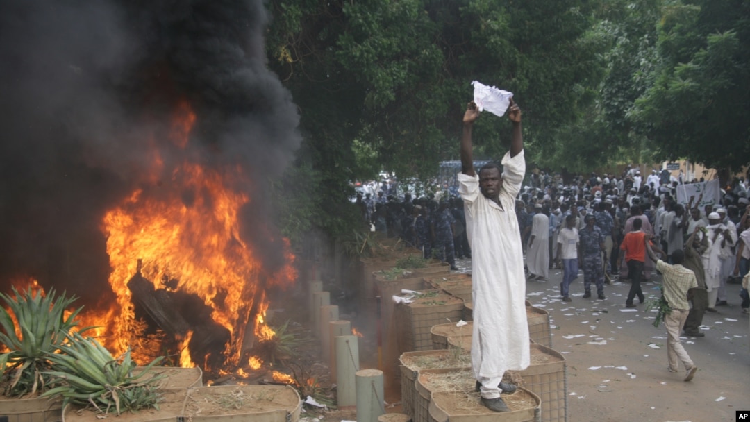 A Sudanese protester stands on a barricade during a demonstration in Khartoum, September 14, 2012, as part of widespread anger across the Muslim world about a film ridiculing Islam's Prophet Muhammad. 