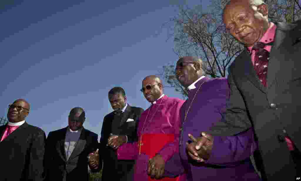 Bishop Abraham Sibiya, 3rd right, and other representatives of churches pray for the health of former South African President Nelson Mandela at the Mediclinic Heart Hospital where he is being treated in Pretoria, South Africa. 