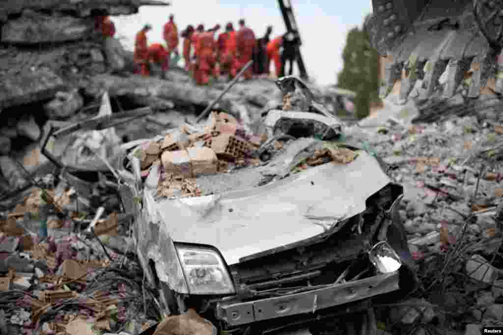 October 26: A destroyed car is seen among the rubble of a collapsed building after the earthquake in Ercis, Turkey. REUTERS/Morteza Nikoubazl 