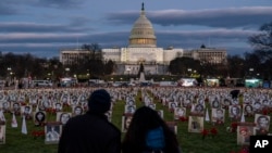 FILE - Protesters walk through a vigil honoring Iranians allegedly killed by their government during a rally in support of the ongoing protests in Iran at the National Mall on Dec. 17, 2022, in Washington.