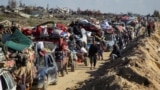 Palestinians, displaced to the south at Israel's order during the war, wait to have their vehicles inspected by the Egyptian-Qatari committee as they return to their homes in northern Gaza, near Gaza City, Jan. 27, 2025. 