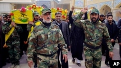 FILE - Mourners carry the coffins of four militia members of a Shiite group, Nujaba movement of Islamic Resistance, during their funeral procession in the Shiite holy city of Najaf, 160 kilometers south of Baghdad, Iraq, Dec. 29, 2015. 