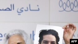 FILE - Debra Tice, mother of US journalist Austin Tice, who was kidnapped in Syria in 2012, holds a dated portrait of him during a press conference in Beirut, Lebanon, July 20, 2017.
