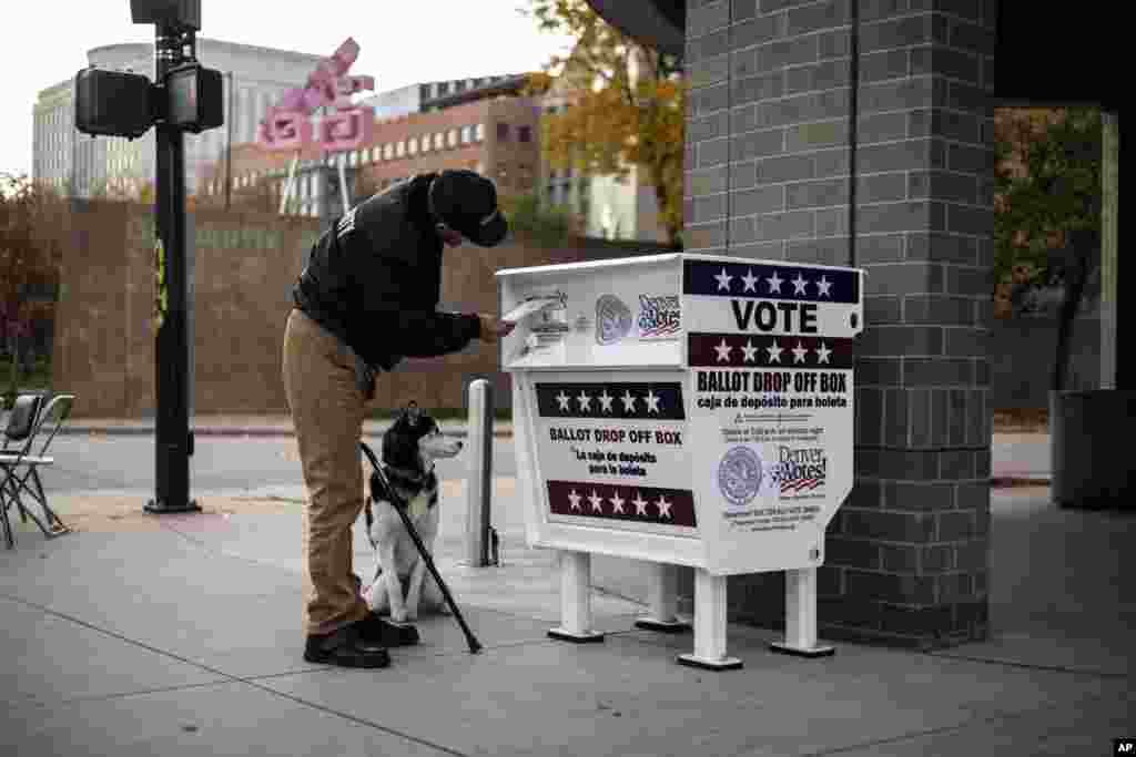 A voter casts his ballot at a drop box in Denver, Colorado, on Election Day, Nov. 5, 2024.