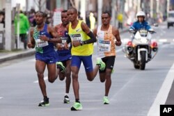 Ethiopea's Birhanu Legese, right, races with other runners on his way to winning the Tokyo Marathon in Tokyo, Japan, March 1, 2020.