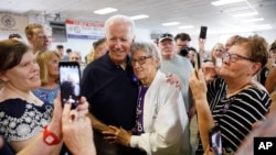 Democratic presidential candidate former Vice President Joe Biden gets a hug from Ruth Nowadzky, of Cedar Rapids, Iowa, during the Hawkeye Area Labor Council Labor Day Picnic in Cedar Rapids, Iowa, Sept. 2, 2019.