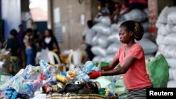 FILE: An employee sorts waste at the Wecycler recycling center in Ebutte Meta district in Lagos, Nigeria. Taken 7.28.2016