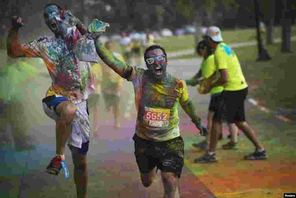 Participants in an amateur "Running in Color" event approach the finish line of a five-kilometer (three-mile) race in Tel Aviv, Israel. Inspired by the Hindu Holi festival, the race involved participants running along a course dotted with locations where colored powders were thrown over the runners. The event was held to raise awareness about Post Traumatic Stress Disorder.