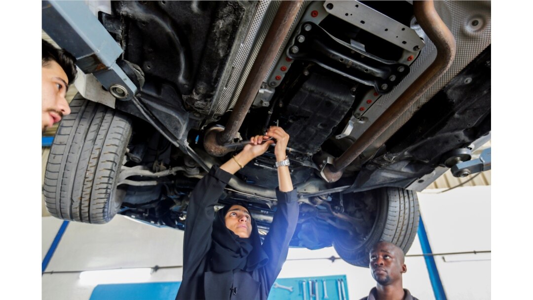 Huda al-Matroushi sedang memperbaiki mobil bersama karyawannya di bengkelnya di Sharjah, Uni Emirat Arab, 21 April 2021. (Foto: Rula Rouhana/Reuters)