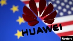 FILE — A 3D printed Huawei logo is placed on glass above a display of EU and US flags in this illustration taken Jan. 29, 2019. 