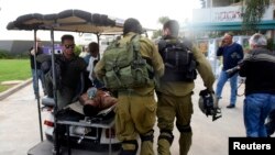 An Israeli soldier, wounded in a firefight along the border with Gaza, is transported to hospital in the southern city of Beersheba December 24, 2014. 