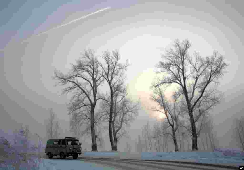 A van drives past frozen trees with the air temperature at about -31 degrees Celsius (-24 degrees Fahrenheit) in Russia's Siberian city of Krasnoyarsk, December 10. ( Ilya Naymushin/Reuters)