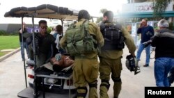 An Israeli soldier, wounded in a firefight along the border with Gaza, is transported to hospital in the southern city of Beersheba, Dec. 24, 2014. 