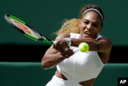 United States' Serena Williams returns to Czech Republic's Barbora Strycova in a Women's semifinal singles match on day ten of the Wimbledon Tennis Championships in London, Thursday, July 11, 2019. (AP Photo/Ben Curtis)