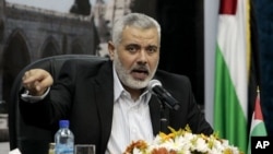 Senior Hamas leader Ismail Haniyeh speaks to the media during a news conference in Gaza City, Monday, May 2, 2011