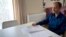 Cafer Topkaya, a former naval officer posted to NATO, looks at his diary, during an interview in his apartment in Brussels, Aug, 27, 2018. 