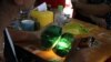 FILE - Local people examine the quality of a jade stone in the Hpakant area of Kachin state, northern Myanmar.