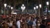 People gather in a popular party area in downtown Barcelona, Spain, early Sunday, July 4, 2021.