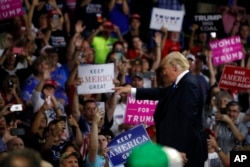 President Donald Trump points to a supporter after speaking during a rally, Aug. 21, 2018, in Charleston, West Virginia.