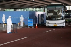 A bus carrying members of the World Health Organization (WHO) team tasked with investigating the origins of the coronavirus disease (COVID-19) pandemic leaves Wuhan Tianhe International Airport in Wuhan, Hubei province, China, Jan. 14, 2021.