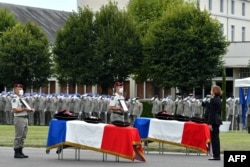 FILE - French Defense Minister Florence Parly pays tribute to the two French soldiers with the Barkhane force in Mali killed when their armored vehicle hit an improvised explosive device, during a tribute ceremony in Tarbes, Sept. 9, 2020.