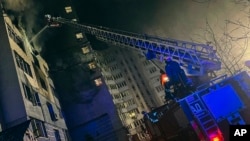 In this photo provided by the Ukrainian Emergency Service, emergency services personnel work to extinguish a fire following a Russian drone attack in the Kyiv region, Ukraine, on Jan. 24, 2025.