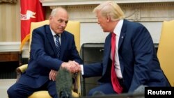 U.S. President Donald Trump shakes hands with John Kelly after he was sworn in as White House Chief of Staff in the Oval Office of the White House in Washington, July 31, 2017.