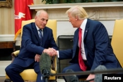 FILE - U.S. President Donald Trump shakes hands with John Kelly after he was sworn in as White House chief of staff, at the White House in Washington, July 31, 2017.