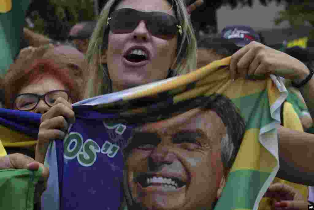 Supporters of presidential candidate Jair Bolsonaro of the right-wing Social Liberal Party, rally in Brasilia, Brazil, one week before Brazilians return to the polls for the second round of voting.