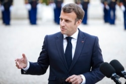 FILE - French President Emmanuel Macron talks with reporters in Paris, April 29, 2021.