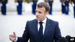 FILE - French President Emmanuel Macron talks with reporters in Paris, April 29, 2021. 
