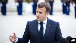 FILE - French President Emmanuel Macron talks with reporters in Paris, April 29, 2021.