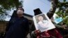 Activists gather for a rally with a photo of Thai dissident Wanchalearm Satsaksit in front of the Cambodian Embassy in Bangkok, Thailand, Monday, June 8, 2020. 