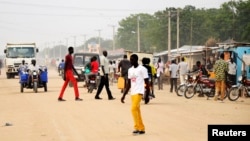 South Sudanese residents walk along a street of Bor, in Jonglei state, Dec. 10, 2014. 