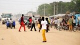 FILE - South Sudanese residents walk along a street of Bor, in Jonglei state, Dec. 10, 2014. Hundreds of residents of Bor are homeless after local authorities demolished their houses Tuesday to make way for new roads.