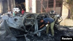 A security official inspects the site where a car bomb exploded in Benghazi, Libya, Aug. 10, 2019.