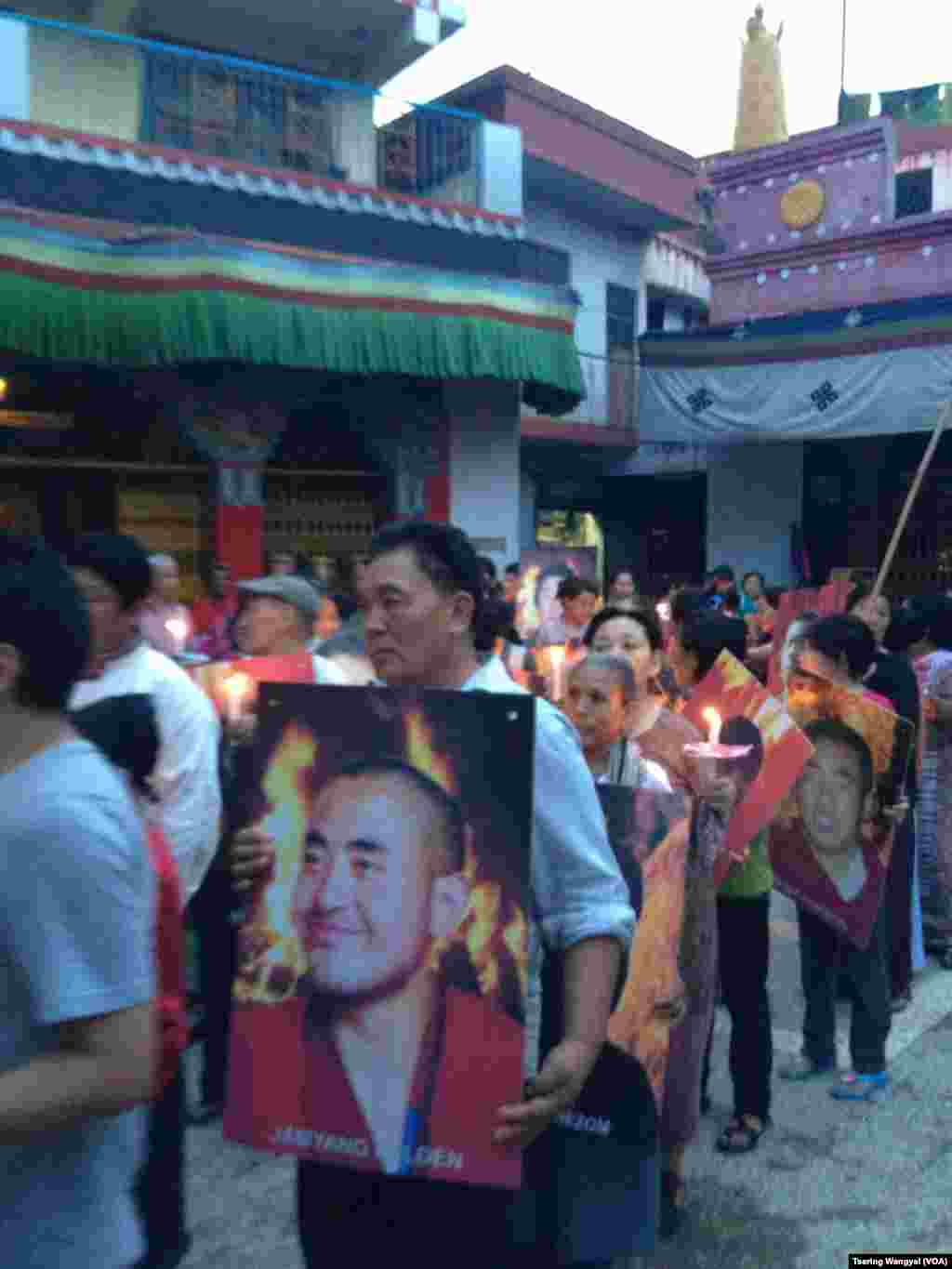 Tibetans in Delhi carrying posters of the Tibetans who self-immolated in China protest evening of August 8, 2012