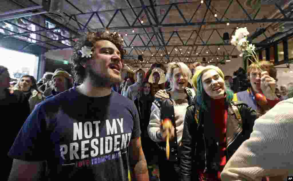 Malachi Belluscio, left, sings "All You Need is Love" along with other audience members during a "bed-in" at local radio station KEXP, marking Inauguration Day, Jan. 20, 2017, in Seattle. 