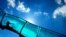 The silhouette of a child is visible in a water slide at an open air swimming pool in Mainz, Germany.
