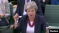 A still image from video footage shows Britain's Prime Minister Theresa May speaking at a Select Committee hearing, in London, Nov. 29, 2018. 