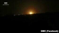 A still image taken from a video posted to a social media website and said to be shot on April 27, 2017, shows explosions and rising flames amid lights in the distance, in Damascus, Syria.