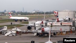 FILE - British Airways planes at Heathrow Terminal 5 in London, Britain, May 27, 2017. 